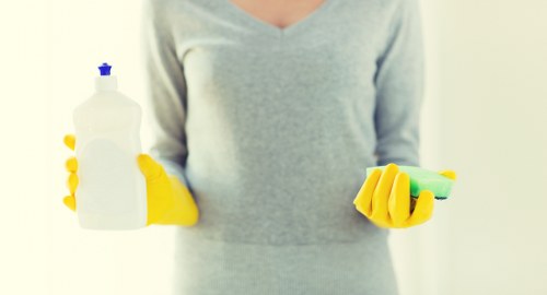 Insured carpet cleaner working carefully in a Roehampton home